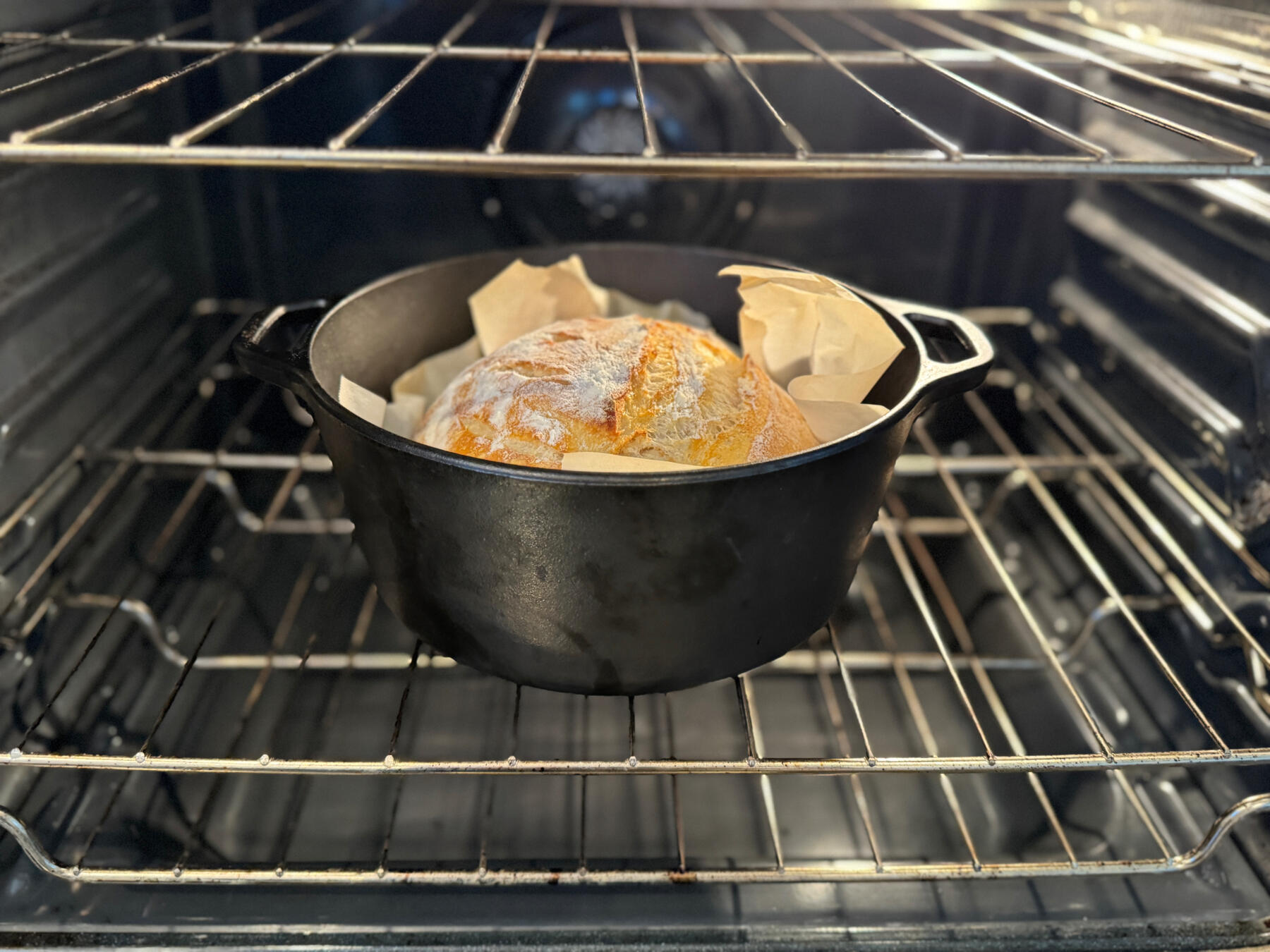 Sourdough Bread Baking in the Oven A loaf of sourdough bread baking in the oven.